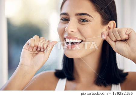 Flossing, dental and woman teeth cleaning for healthcare and wellness in a home bathroom. Healthy smile and dentist care of a person with happiness from dental care and teeth whitening results Flossing, dental and woman teeth cleaning for healthcare and wellness in a home bathroom. Healthy smile and dentist care of a person with happiness from dental care and teeth whitening results 129222196