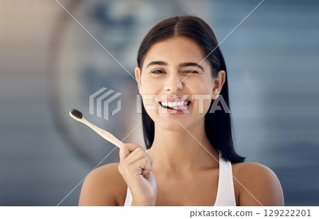 Cleaning, wooden toothbrush and woman in bathroom with cute expression on face ready for brushing teeth. Dentistry, oral healthcare and girl with natural, organic and eco friendly dental care product 129222201