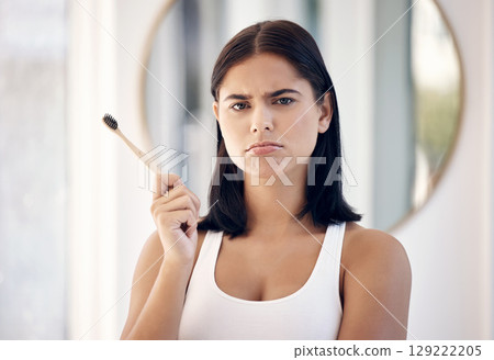 Makeup, beauty and face with a moody woman in the bathroom of her home to apply cosmetics to her skin. Portrait, make up and brush with an attractive young female feeling down or sad in the house Makeup, beauty and face with a moody woman in the bathroom of her home to apply cosmetics to her skin. Portrait, make up and brush with an attractive young female feeling down or sad in the house 129222205