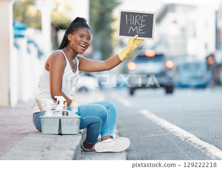 Woman, street and poster for looking for job or hiring for cleaning service, work or opportunity in city. Black woman, cleaner or domestic freelancer on metro sidewalk with basket, sign or product Woman, street and poster for looking for job or hiring for cleaning service, work or opportunity in city. Black woman, cleaner or domestic freelancer on metro sidewalk with basket, sign or product 129222218