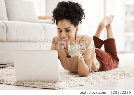 Computer remote work, black woman and living room floor with morning coffee working on an email. African woman happy on wifi, laptop and technology job online with a smile in a living room house Computer remote work, black woman and living room floor with morning coffee working on an email. African woman happy on wifi, laptop and technology job online with a smile in a living room house 129222229