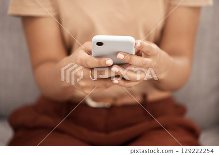 Phone, hands and woman texting closeup on a sofa, social media or online chatting in a living room. Zoom, hand and girl internet search, browsing or checking news update, meme or post in her home Phone, hands and woman texting closeup on a sofa, social media or online chatting in a living room. Zoom, hand and girl internet search, browsing or checking news update, meme or post in her home 129222254