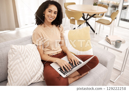 Laptop, black woman and portrait on living room sofa in work from home office for planning, internet research or technology. Freelancer, blogger and lady typing email on computer in apartment lounge 129222258