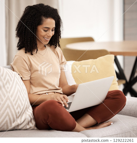 Remote work, black woman and living room sofa of person at home on a laptop working. Digital employee and woman on a sofa using technology for digital marketing job online on a computer and couch Remote work, black woman and living room sofa of person at home on a laptop working. Digital employee and woman on a sofa using technology for digital marketing job online on a computer and couch 129222261