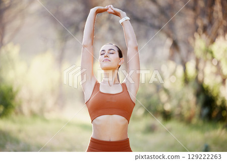 Meditation, yoga and zen woman in nature relaxing, training or stretching her body with freedom for a calm balance. Fitness, pilates and peaceful girl in a park to meditate for a mindfulness exercise 129222263