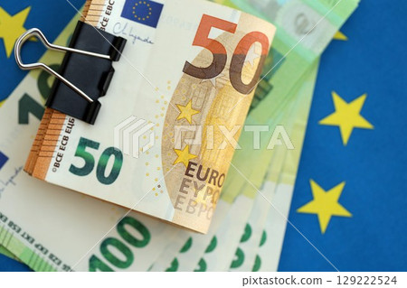 European euro currency money notes bunch on Europe union blue flag close up European euro currency money notes bunch on Europe union blue flag close up 129222524