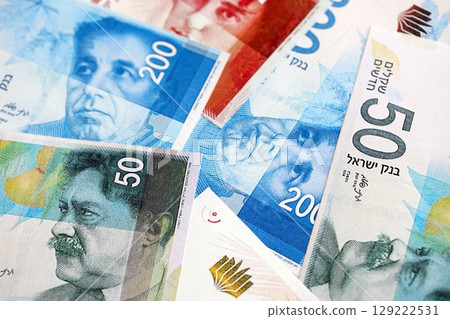 Israel New Shekels banknotes. The current Israel money bills lies on table in big amount Israel New Shekels banknotes. The current Israel money bills lies on table in big amount 129222531