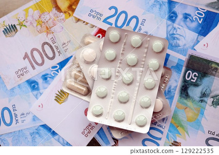 Israel New Shekels banknotes and medicine pills. The current Israel money bills and drugs Israel New Shekels banknotes and medicine pills. The current Israel money bills and drugs 129222535