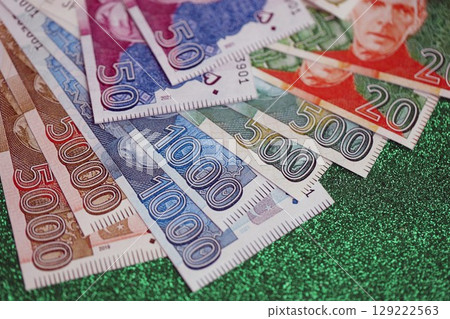 Pakistan rupees banknotes on glitter green background. The current Pakistan money bills Pakistan rupees banknotes on glitter green background. The current Pakistan money bills 129222563