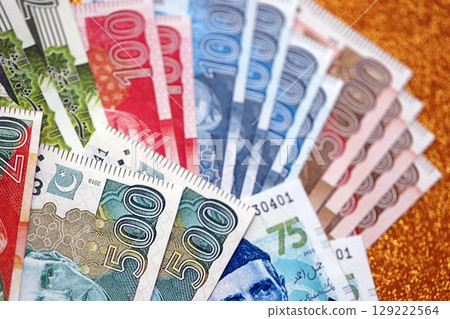 Pakistan rupees banknotes on golden yellow background. The current Pakistan money bills 129222564
