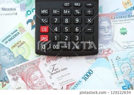 Nigerian naira currency money bills and calculator. The concept of taxation and money count 129222634