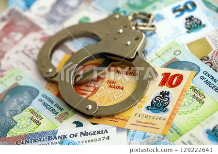 Nigerian naira currency money bills and handcuffs. The concept of criminal Nigerian naira currency money bills and handcuffs. The concept of criminal 129222641