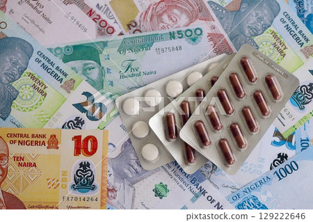 Nigerian naira currency money bills and medicine pills. The concept of medicine and pharmacy 129222646