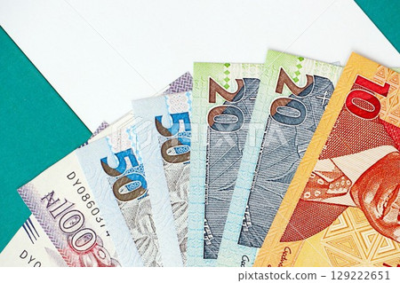 Nigerian naira currency money bills lies on flag. The concept of business and investment 129222651