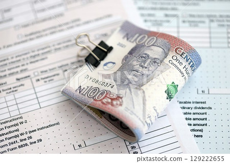 Nigerian naira money bills on tax form. Taxation and accounting concept Nigerian naira money bills on tax form. Taxation and accounting concept 129222655