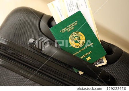 Nigerian passport and avia tickets on travel bag. The concept of travel and vacation Nigerian passport and avia tickets on travel bag. The concept of travel and vacation 129222658