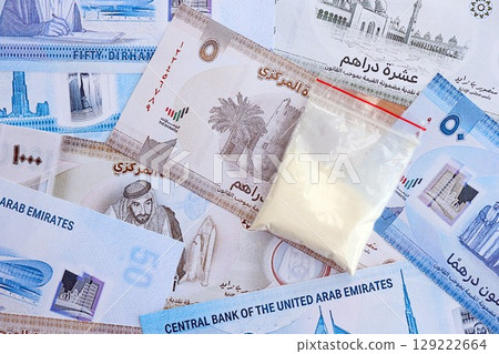 United Arab Emirates dirham currency money bills and cocaine pack. The concept of drug trafficking 129222664