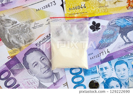 Philippines peso currency money bills and cocaine pack. The concept of drug trafficking Philippines peso currency money bills and cocaine pack. The concept of drug trafficking 129222690