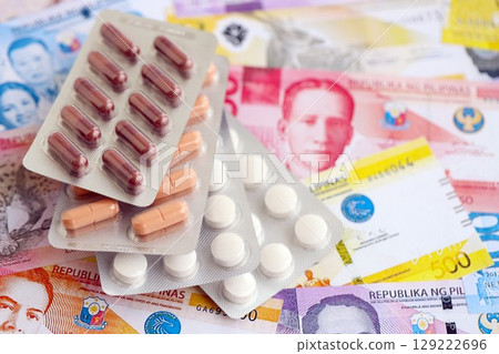 Philippines peso currency money bills and medicine pills. The concept of medicine and pharmacy Philippines peso currency money bills and medicine pills. The concept of medicine and pharmacy 129222696
