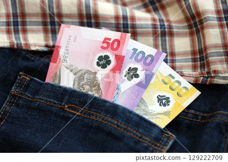 Philippines peso money bills in denims pocket. The concept of fashion and wealth Philippines peso money bills in denims pocket. The concept of fashion and wealth 129222709