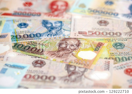 Vietnamese dong currency money bills. The current banknotes lies on table in big amount Vietnamese dong currency money bills. The current banknotes lies on table in big amount 129222710