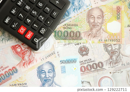 Vietnamese dong currency money bills and calculator. The concept of taxation and money count Vietnamese dong currency money bills and calculator. The concept of taxation and money count 129222711