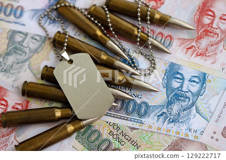 Vietnamese dong currency money bills and rifle bullets with dogtag. The concept of warfare and army service 129222717