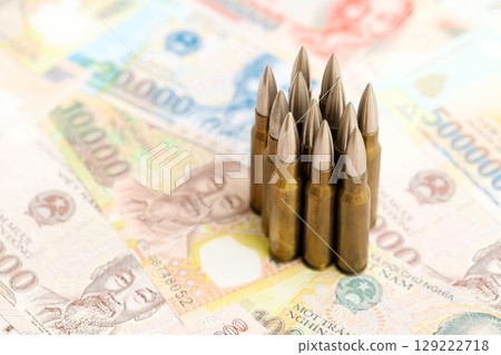 Vietnamese dong currency money bills and rifle bullets. The concept of warfare and gun selling 129222718