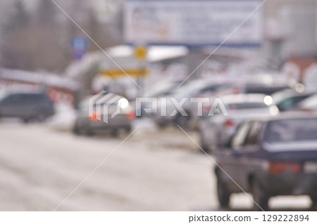 Blurred winter street scene with cars and snow covered landscape in urban 129222894