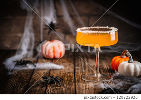 Halloween-Themed Cocktail with Pumpkins and Spider Decoration Halloween-Themed Cocktail with Pumpkins and Spider Decoration 129222926