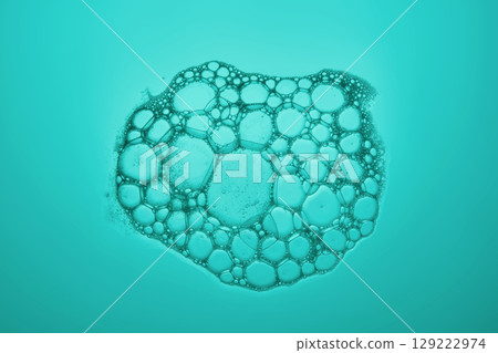 The texture of soap bubbles and foam in close-up on a green background. 129222974