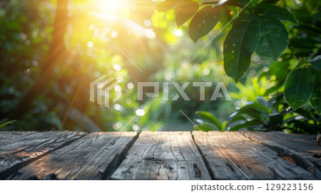 Vibrant spring foliage and blooming branches with wooden table in garden sunlight Vibrant spring foliage and blooming branches with wooden table in garden sunlight 129223156