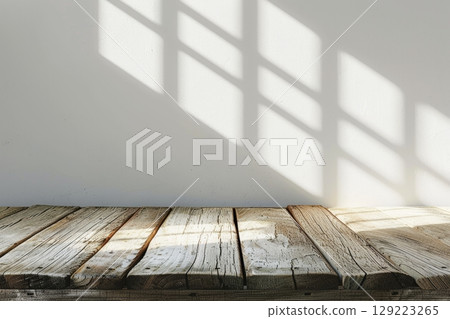 Empty Wooden Table Top With Sunlight From Window On White Wall, Background For Product Display 129223265