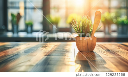 Small Potted Plant on a Wooden Tabletop with Sun Shining Through Window, Minimalistic Home Decor 129223266