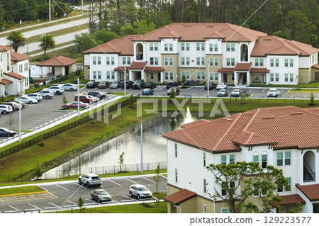 Aerial view of american apartment buildings in Florida residential area. New family condos as example of housing development in US suburbs 129223577