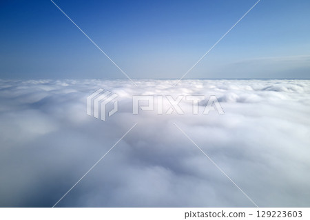 Aerial view from high altitude of earth covered with puffy rainy clouds forming before rainstorm Aerial view from high altitude of earth covered with puffy rainy clouds forming before rainstorm 129223603