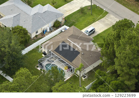 Aerial landscape view of suburban private houses between green palm trees in Florida quiet rural area Aerial landscape view of suburban private houses between green palm trees in Florida quiet rural area 129223699
