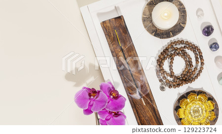 Self-care, healing banner with rosary beads, candles, aroma sticks, chakra stones and orchids on white wooden tray with copy space. Concept of me time, relaxing at home, energy healing and meditation Self-care, healing banner with rosary beads, candles, aroma sticks, chakra stones and orchids on white wooden tray with copy space. Concept of me time, relaxing at home, energy healing and meditation 129223724