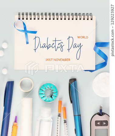 Diabetes Day. Glucose meter, test strips for determining blood sugar levels, syringes for insulin injections, sanitizing on a blue background with notebook with inscription World Diabetes Day 129223927
