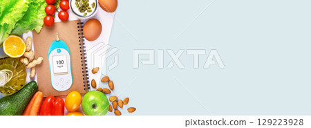 Diabetes banner. Concept of no diabetes and control of glycemia with a diet. Organic vegetables and fruits, olive oil and glucometer with the result of good glycemia on blue background with copy space Diabetes banner. Concept of no diabetes and control of glycemia with a diet. Organic vegetables and fruits, olive oil and glucometer with the result of good glycemia on blue background with copy space 129223928
