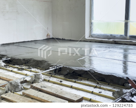 Floor screeding with cement over heated pipes. Floor screeding with cement over heated pipes. 129224783