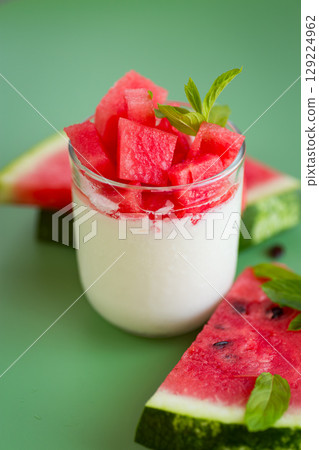 Summer fruit snack made of yogurt with bright slices of ripe watermelon Summer fruit snack made of yogurt with bright slices of ripe watermelon 129224962