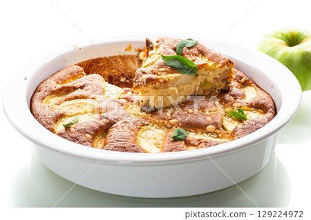 Ruddy crust of an appetizing apple pie on a white background 129224972