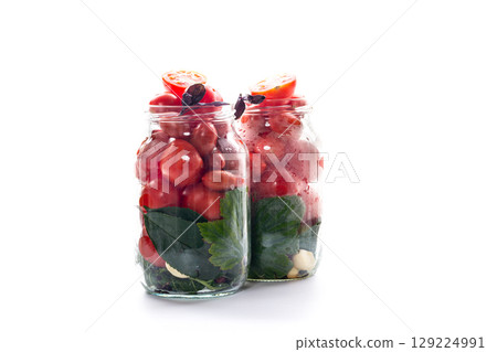 Homemade red tomatoes with herbs in a jar Homemade red tomatoes with herbs in a jar 129224991