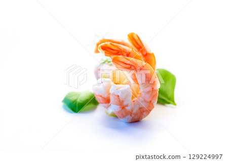 Peeled shrimp with basil close-up on a white background Peeled shrimp with basil close-up on a white background 129224997