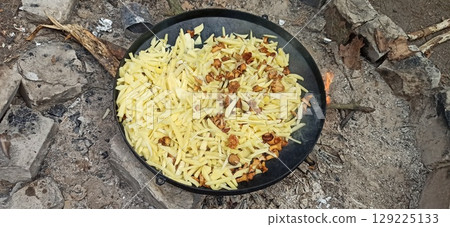 Tractor with potato harvester on the field. Process of digging potatoes 129225133