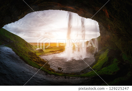 Perfect view of famous powerful Seljalandsfoss waterfall in sunlight. Location place Iceland, sightseeing Europe. Perfect view of famous powerful Seljalandsfoss waterfall in sunlight. Location place Iceland, sightseeing Europe. 129225247