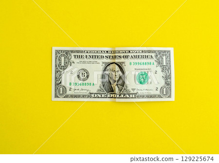 Dollar on a yellow background, background with copy space. 129225674