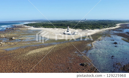 Solitary Beacon Guarding Wind-Swept Coastal Sands 129225968