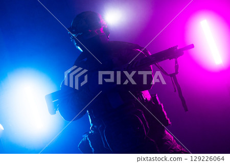 Tactical Soldier in Action Helmet On Off Dramatic Lights Smoke 129226064
